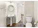 Well-lit half bathroom featuring tile floors and a pedestal sink at 7840 Red Leaf Dr, Las Vegas, NV 89131