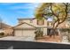 Inviting two-story home with a three car garage and well-maintained front yard at 7840 Red Leaf Dr, Las Vegas, NV 89131