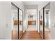 Hallway lined with sliding mirrored closet doors leading to a bright bathroom at 7840 Red Leaf Dr, Las Vegas, NV 89131