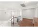 Bright hallway with hardwood floors, decorative railing, and multiple windows offering natural light at 7840 Red Leaf Dr, Las Vegas, NV 89131