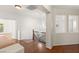 Upstairs hallway boasting hardwood floors, white walls, and a wrought iron railing at 7840 Red Leaf Dr, Las Vegas, NV 89131