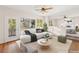 Staged living room features a modern couch, round coffee table, and plenty of natural light at 7840 Red Leaf Dr, Las Vegas, NV 89131