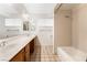 Bright bathroom featuring double sinks and a shower-tub combo at 845 Palo Verde Dr, Henderson, NV 89015