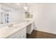 White bathroom vanity with double sinks, a large mirror and neutral walls at 845 Palo Verde Dr, Henderson, NV 89015