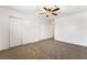 Neutral carpeted bedroom with a ceiling fan and ample closet space at 845 Palo Verde Dr, Henderson, NV 89015