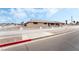 Classic single story house with a beautiful white fence and a wide street view under a partly cloudy sky at 845 Palo Verde Dr, Henderson, NV 89015