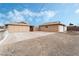 View of two detached garages with white doors and a spacious driveway under a blue sky at 845 Palo Verde Dr, Henderson, NV 89015