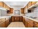 Traditional kitchen with white countertops, tile backsplash, and wood cabinets at 845 Palo Verde Dr, Henderson, NV 89015