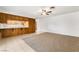 Open living room with ceiling fan, carpet, and view into adjacent kitchen area at 845 Palo Verde Dr, Henderson, NV 89015