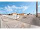 Street view showcasing the home's architecture and neighborhood charm under a blue and cloudy sky at 845 Palo Verde Dr, Henderson, NV 89015