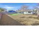 Spacious backyard with grass, patio, mature trees, and rock landscaping at 865 Armada Pl, Boulder City, NV 89005