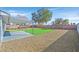 Backyard featuring a covered patio area with grass and rock landscaping at 865 Armada Pl, Boulder City, NV 89005