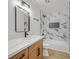 Bright bathroom with a modern vanity and updated shower with marble tile at 865 Armada Pl, Boulder City, NV 89005