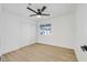 Bright bedroom featuring light hardwood floors, ceiling fan, and a large closet at 865 Armada Pl, Boulder City, NV 89005