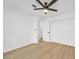 Neutral bedroom featuring light hardwood floors, ceiling fan, and a large closet at 865 Armada Pl, Boulder City, NV 89005