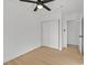 Neutral bedroom featuring light hardwood floors, ceiling fan, and a large closet at 865 Armada Pl, Boulder City, NV 89005