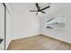 Bright bedroom featuring light hardwood floors, ceiling fan, and a large closet at 865 Armada Pl, Boulder City, NV 89005