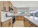 Beautiful kitchen featuring an island, stainless steel appliances, and herringbone backsplash at 865 Armada Pl, Boulder City, NV 89005