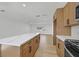 Bright kitchen featuring an island with white countertops and new stainless steel appliances at 865 Armada Pl, Boulder City, NV 89005