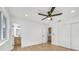 Spacious bedroom featuring light hardwood floors, ceiling fan, and an ensuite bathroom at 865 Armada Pl, Boulder City, NV 89005