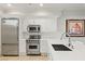 Modern kitchen featuring stainless steel appliances, white cabinets and marble backsplash at 9101 Alta Dr # 103, Las Vegas, NV 89145