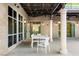 Outdoor dining area on a covered patio with stone columns and ornate metalwork at 9101 Alta Dr # 103, Las Vegas, NV 89145