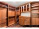 This primary closet is equipped with custom wood shelving and cabinetry at 9101 Alta Dr # 103, Las Vegas, NV 89145