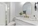 Modern bathroom with white marble countertop, gold fixtures, and a glass shower at 9541 Summersweet Ct, Las Vegas, NV 89123