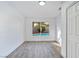 Bright bedroom with light wood floors and a window view of the backyard pool area at 9541 Summersweet Ct, Las Vegas, NV 89123