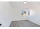 Bedroom features wood flooring, two bright windows, and clean white walls at 9541 Summersweet Ct, Las Vegas, NV 89123