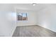 This bedroom features wood flooring, a bright window, and clean white walls at 9541 Summersweet Ct, Las Vegas, NV 89123