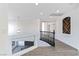 Upstairs hallway with modern chandelier and a view of the staircase below at 9541 Summersweet Ct, Las Vegas, NV 89123