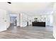 Spacious kitchen featuring white cabinetry, stainless steel appliances, and hardwood flooring at 9541 Summersweet Ct, Las Vegas, NV 89123