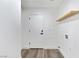 Clean laundry area with white walls, door, and a simple wooden shelf at 9541 Summersweet Ct, Las Vegas, NV 89123