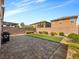 Paver patio and strip of grass in backyard with desert landscaping along the wall at 9734 Cluny Ave, Las Vegas, NV 89178