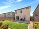 Beautiful backyard with a lawn, paver patio, and desert landscaping along the wall at 9734 Cluny Ave, Las Vegas, NV 89178