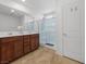 Bright bathroom with a double vanity, framed mirrors, and a glass-enclosed shower at 9734 Cluny Ave, Las Vegas, NV 89178