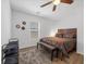 This bedroom features a ceiling fan, a large window and a wood-framed bed at 9734 Cluny Ave, Las Vegas, NV 89178