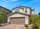 Charming two-story home with a brick driveway, a two-car garage, and low maintenance landscaping at 9734 Cluny Ave, Las Vegas, NV 89178