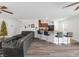 Stylish living room with open layout to the kitchen, showcasing hardwood floors and neutral walls at 9734 Cluny Ave, Las Vegas, NV 89178