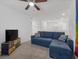 Comfortable living room featuring an L shaped couch and a TV on a cabinet at 9734 Cluny Ave, Las Vegas, NV 89178