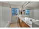 Bathroom featuring a double sink vanity with a tiled bathtub at 1 Rising Sun Ct, Henderson, NV 89074