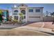 Elegant two-story home featuring a symmetrical facade, arched windows, and a brick driveway at 1 Rising Sun Ct, Henderson, NV 89074