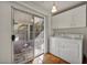 This laundry room has a sliding glass door, and white washer and dryer at 1 Rising Sun Ct, Henderson, NV 89074
