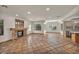 Spacious living area with a brick fireplace, tiled floors, and an open layout connecting to the kitchen at 1 Rising Sun Ct, Henderson, NV 89074