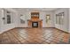 Bright living room showcasing a brick fireplace, tiled floors, and an open floor plan for versatile living at 1 Rising Sun Ct, Henderson, NV 89074