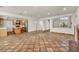 Open living space with a brick fireplace, tiled flooring, and views into the adjacent kitchen area at 1 Rising Sun Ct, Henderson, NV 89074