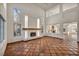 Bright living room with high ceilings, a tiled fireplace, and large windows providing ample natural light at 1 Rising Sun Ct, Henderson, NV 89074