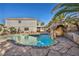 Beautiful backyard pool featuring rock features and extensive stonework at 1 Rising Sun Ct, Henderson, NV 89074