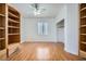 Sunlit bedroom with hardwood floors, ceiling fan, and bonus built-in shelving at 10529 Morning Drop Ave, Las Vegas, NV 89129